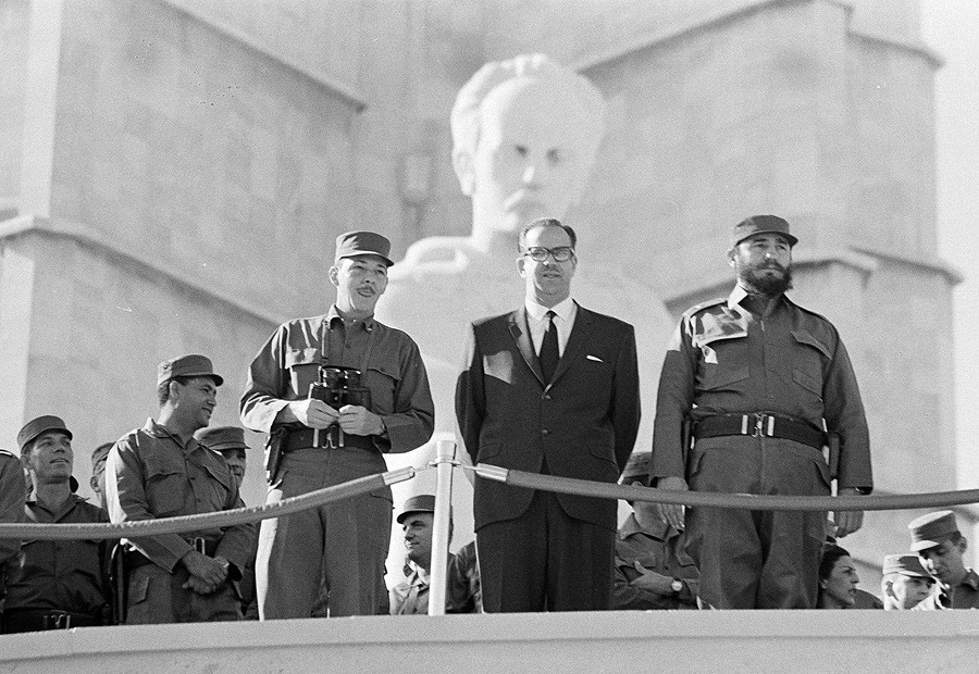 2 The Cuban Prime Minister Fidel Castro, President Osvaldo Dorticos and  Armed Forces Chief, Commander Raul Castro, watch as Cuban military units  7th anniversary of the overthrow of the Batista regime, January 2, 1966 - AP.jpg